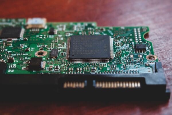 Macro closeup HDD green PCB with main control chip, SATA connector and fiducia mark