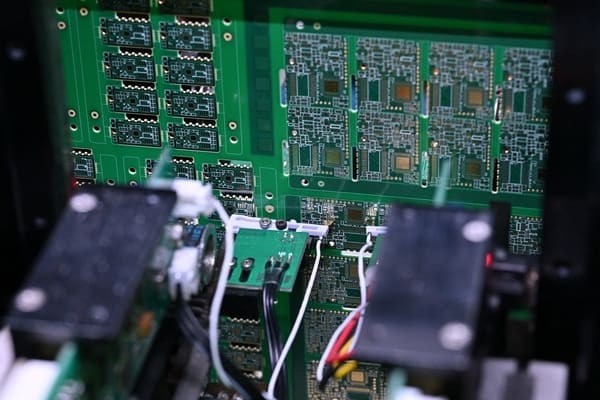 Batch PCBA circuit boards in FCT test fixture with cables