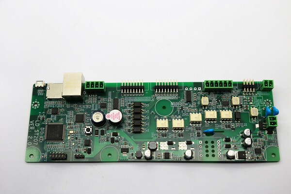 SMT assembled LD?ST207 VER 2.0 industrial PCBA circuit board, surface?mounted chips resistors capacitors, Ethernet port and terminal connectors on green FR?4 PCB against plain white background