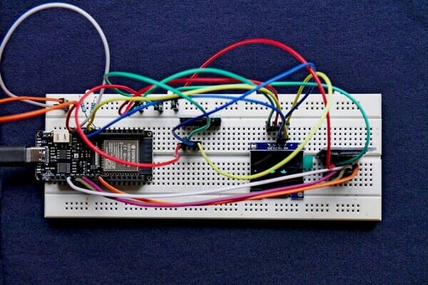 ESP32 circuit on breadboard with OLED screen and sensors